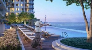 lady appreciating the beachfront view from the pool