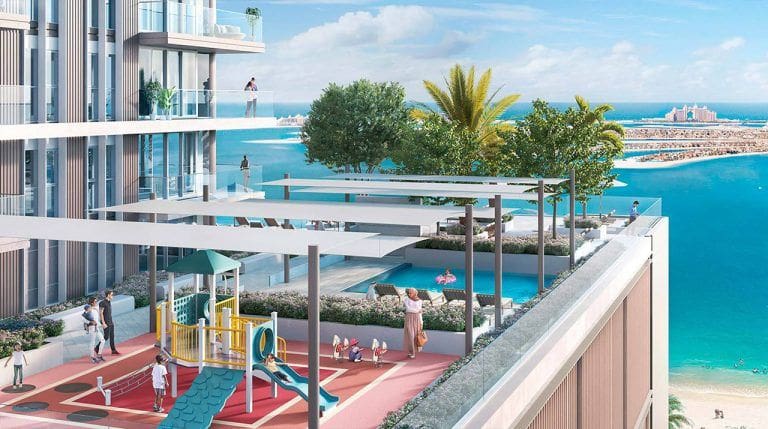 childrens outdoor play area with partial view of beach isle balconies and the beach in the background
