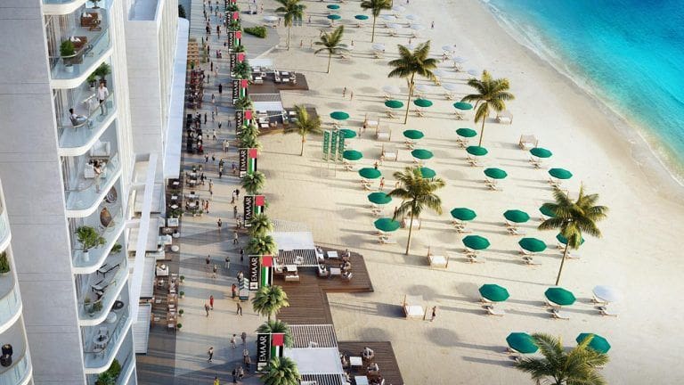 view of sandy beach with umbrellas from one of south beach furnished apartment balconies