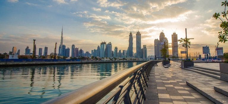 view of dubai skyline from dubai canal walkway near sobha hartland