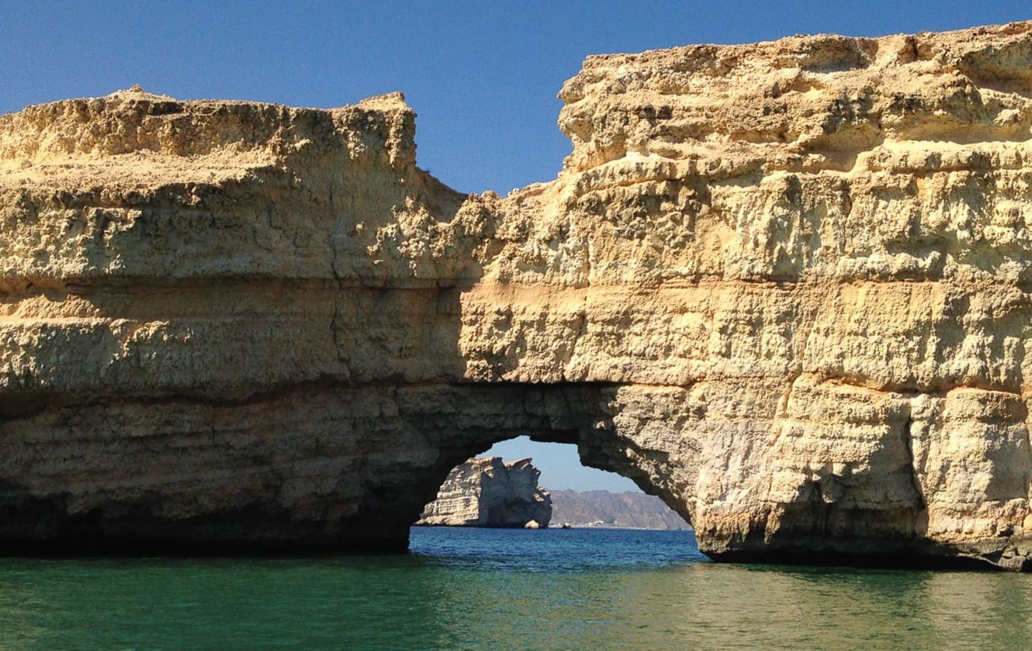 Rock arch at Al Jissah on the Gulf of Oman coastline, near Muscat Bay