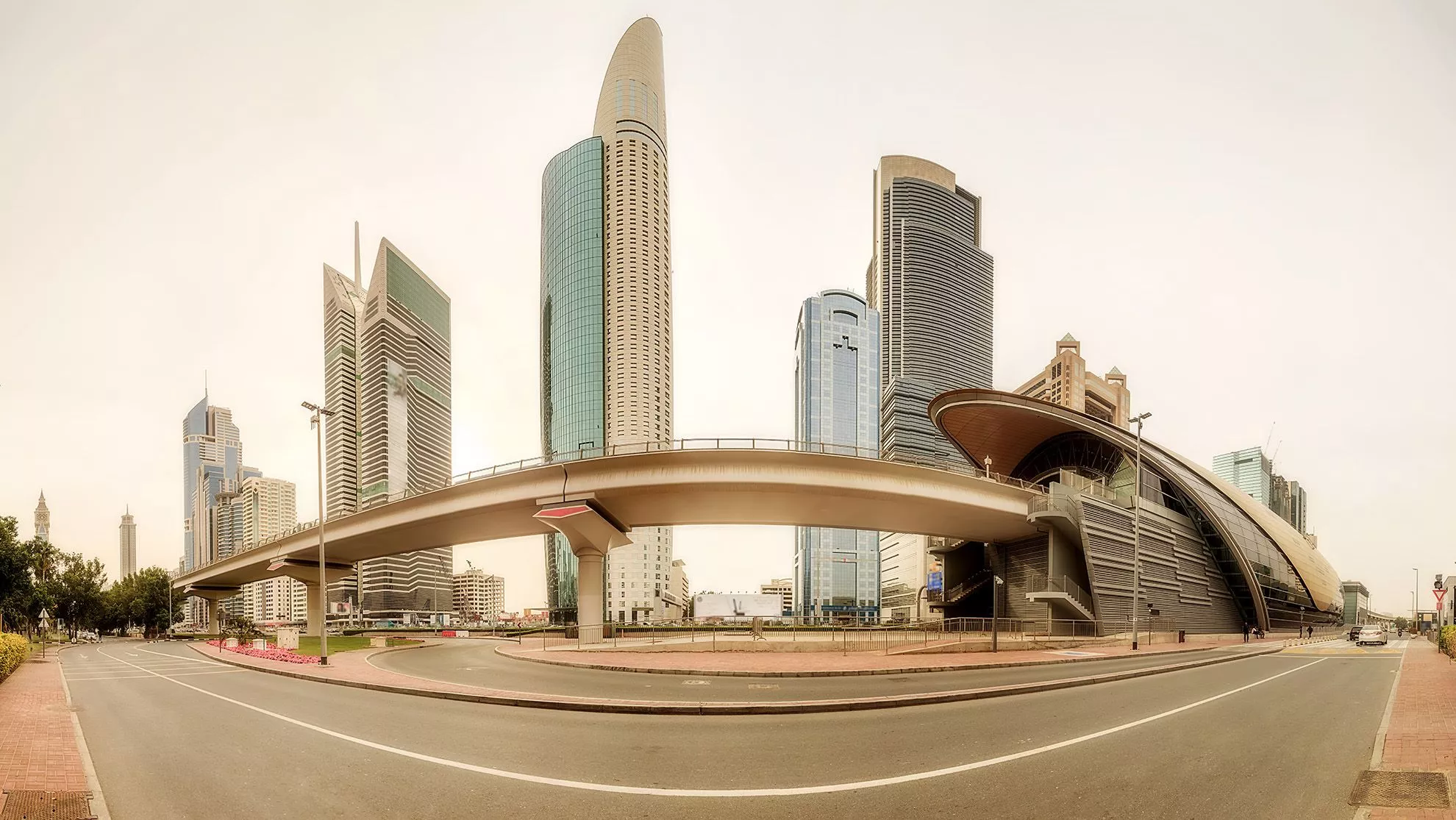 Panoramic view of metro station and road in Dubai Financial district
