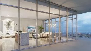 view from outside of the interior of a living room with dining room and kitchen island